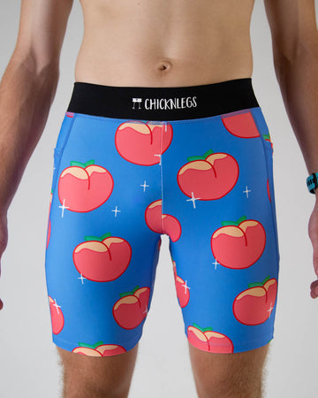 A close up photo of ChicknLegs men’s 8-inch half tights, breathable liner, blue background and juicy peaches design.