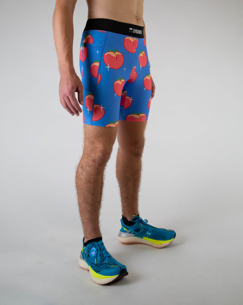Right side view of ChicknLegs men’s 8-inch half tights, breathable liner, blue background and juicy peaches design. Side pockets are visible in the photo.