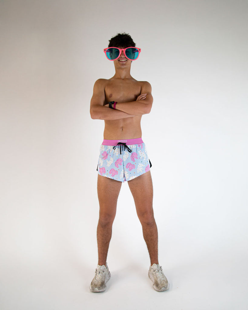Runner is wearing ChicknLegs in the men's 2 in drawstrings split running shorts in the Animal Cookies design while wearing giant fun pink sunglasses.
