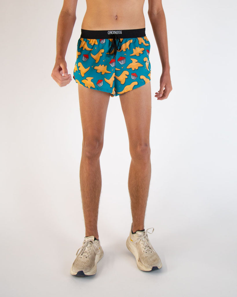 Runner is wearing ChicknLegs in the men's 2 in drawstrings in the split running shorts. The design has dinosaur  chicken nuggets on them with ketchup sauces. 