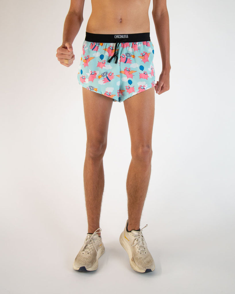 Runner is wearing ChicknLegs in the men's 2 in drawstrings in the split running shorts. The print has flying pigs on it with pink, blue, and white colors.