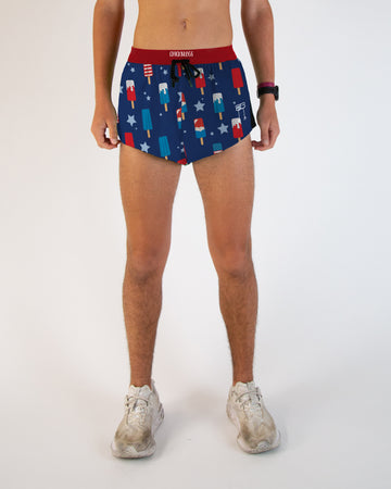 Runner is wearing ChicknLegs in the men's 2 in split running shorts with drawstrings. The print has a USA American theme print that has popsicles in red, white and blue along with stars.