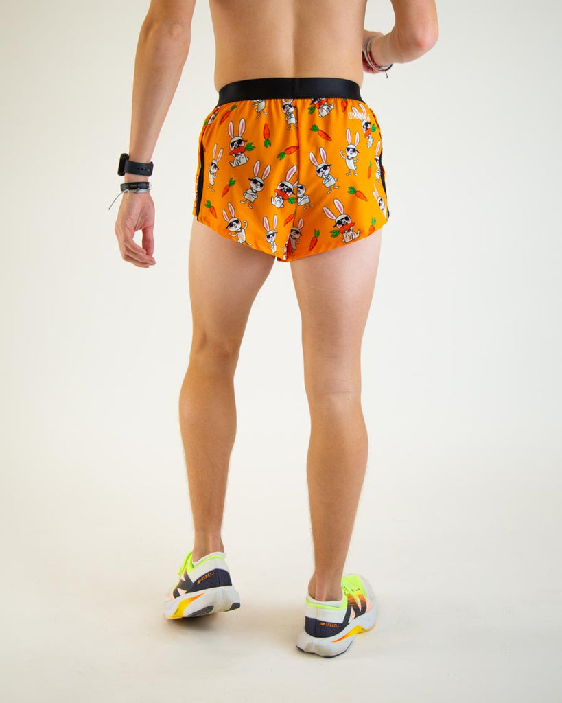 Runner is wearing ChicknLegs in the men's 2 in split running shorts with the bad bunny design. The print has white rabbit on it and carrot, showing the back view of the shorts.