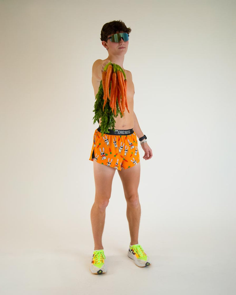 Runner is wearing ChicknLegs in the men's 2 in split running shorts with the bad bunny design. The print has white rabbits on it with sunglasses and carrot while posing with real carrots and fun viper sunglasses.