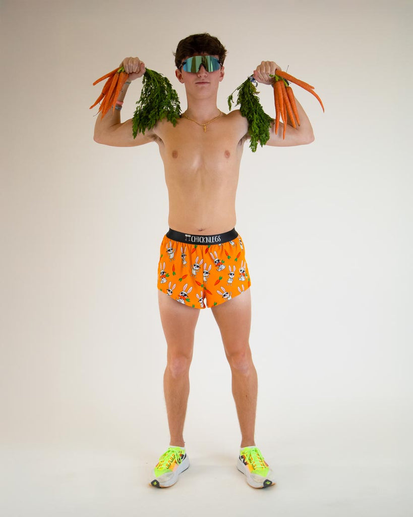 Runner is wearing ChicknLegs in the men's 2 in split running shorts with the bad bunny design. The print has white rabbits on it with sunglasses and carrots as lifting weights. 