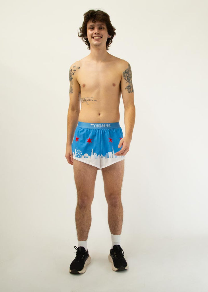 Runner is wearing Chicknlegs in the men's 2 in split running shorts in the Chicago Style Skylines that has a white city on it and a blue sky with red stars for marathon runners.