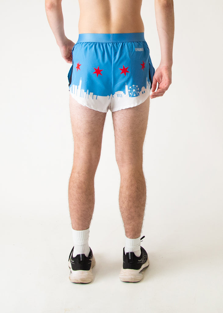 Runner is wearing Chicknlegs in the men's 2 in split running shorts in the Chicago Style Skylines that has a white city on it and a blue sky with red stars for marathon runners to help prevent chaffing. 