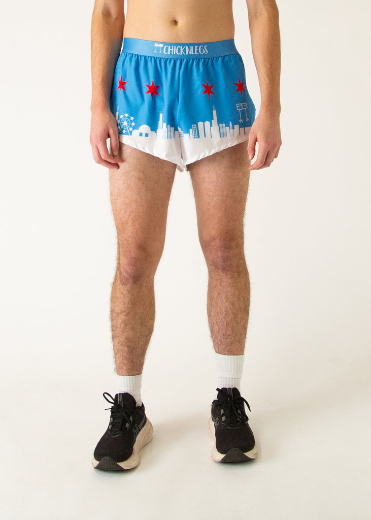Runner is wearing Chicknlegs in the men's 2 in split running shorts in the Chicago Style Skylines that has a white city on it and a blue sky with red stars for marathon runners.