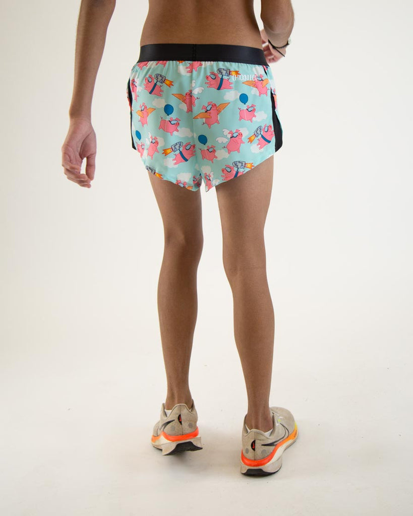 Runner is wearing ChicknLegs in the men's 2 in split running shorts in the flying pigs design. The print has pink piggies on it with goggles, cardboard, wings, and jetpacks.