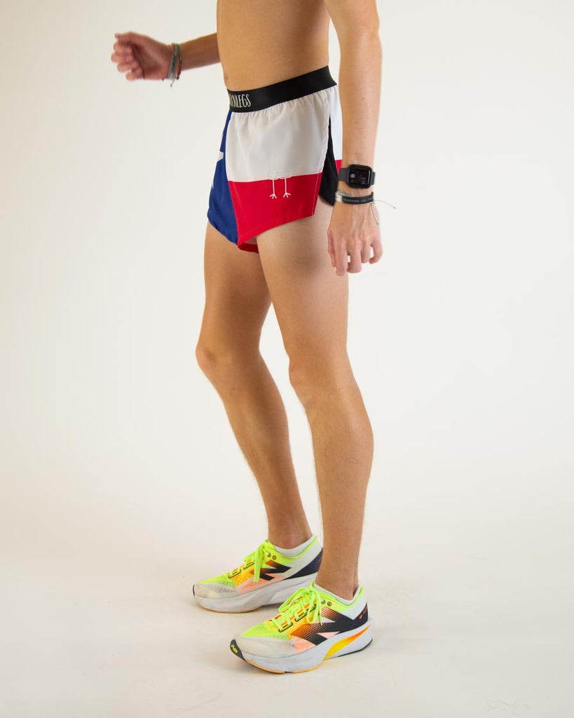 Model is wearing ChicknLegs in the men's 2 in split running shorts n the texas flag design, facing left.