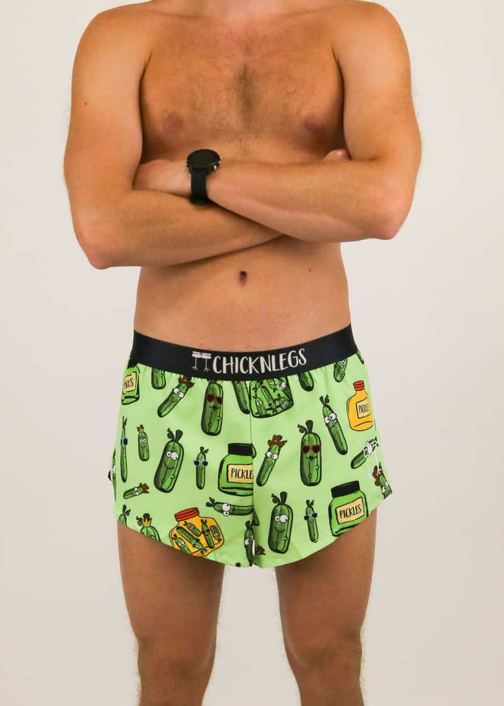 Front closeup view of the men's 2 inch split running shorts with a green pickle design.