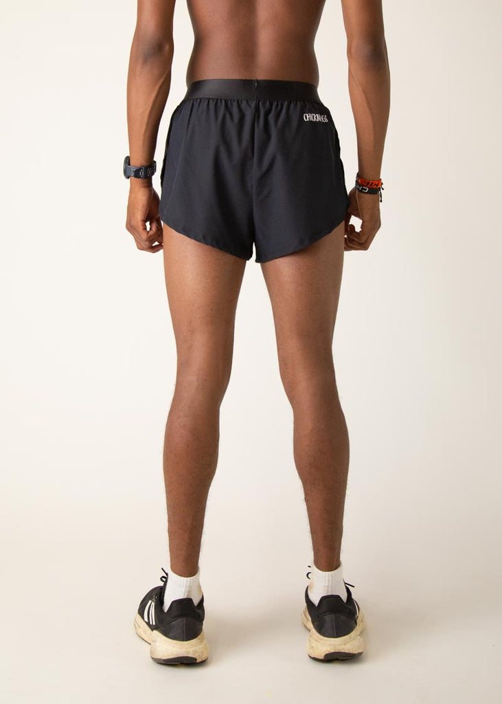 Model is wearing Chicknlegs in the mens 2 inch split running shorts in the black design, facing away from the camera to show the back view.