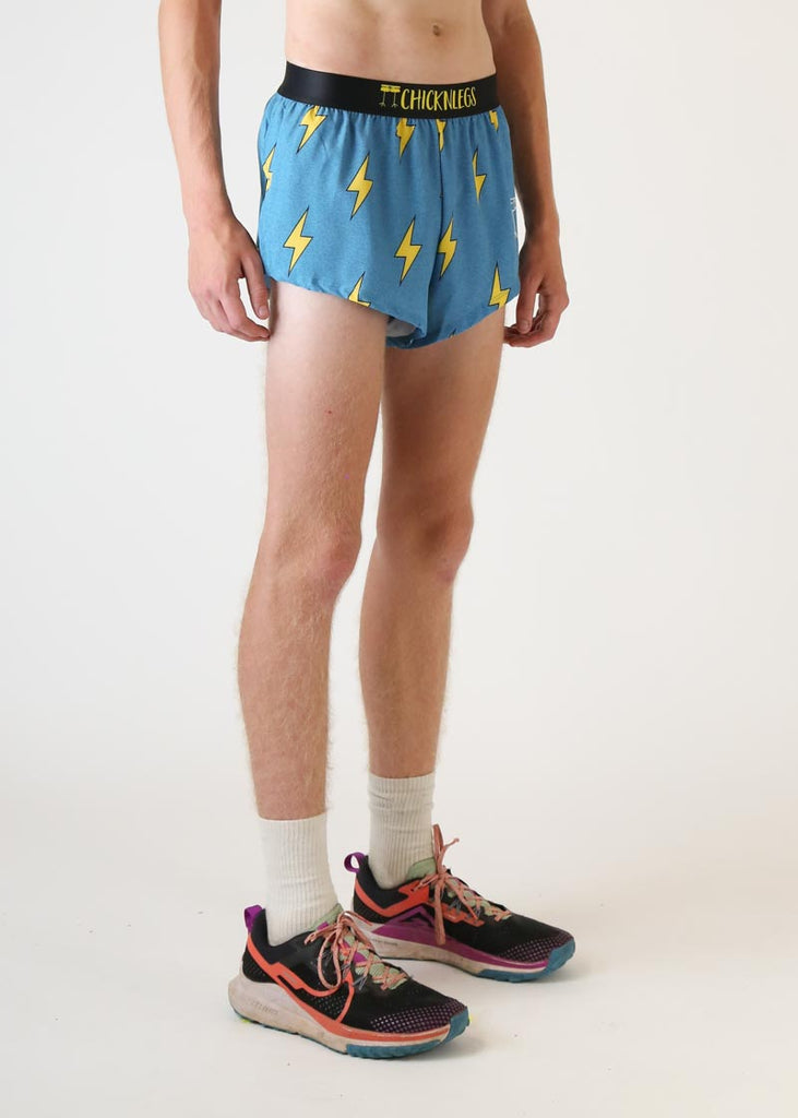 Model wearing chicknlegs mens 2 inch split running shorts with blue bolts design right side view