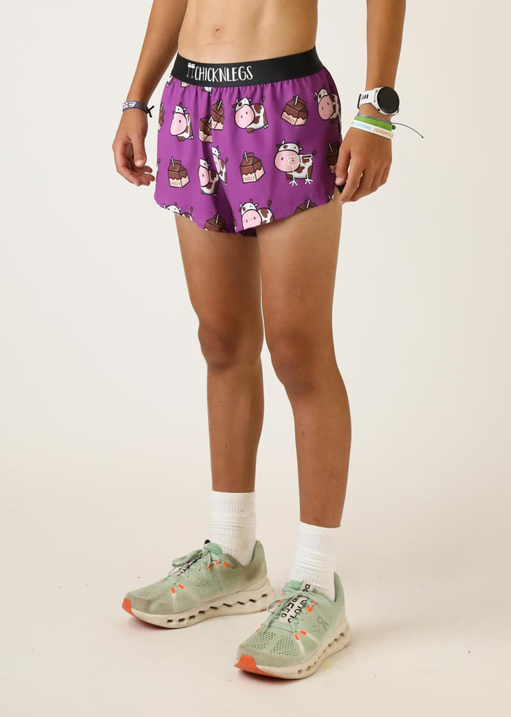Model wearing chicknlegs mens 2 inch split running shorts with choccy cow design left side view
