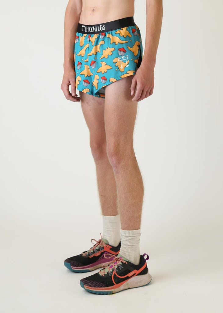 Model wearing Chicknlegs mens 2 inch split running shorts in dino nugget design left side view