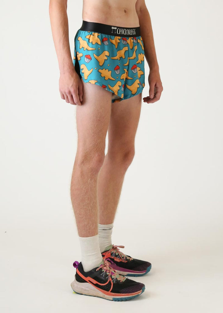 Model wearing Chicknlegs mens 2 inch split running shorts in dino nugget design right view