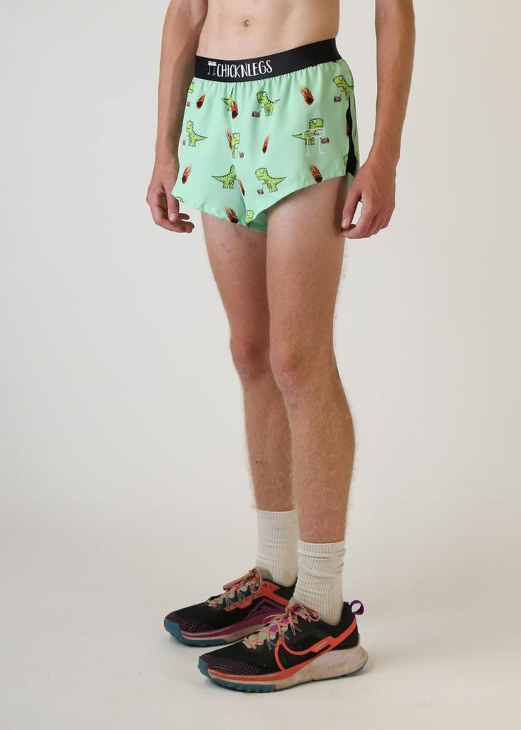 Model wearing chicknlegs mens 2 inch split running shorts with dinos design left view