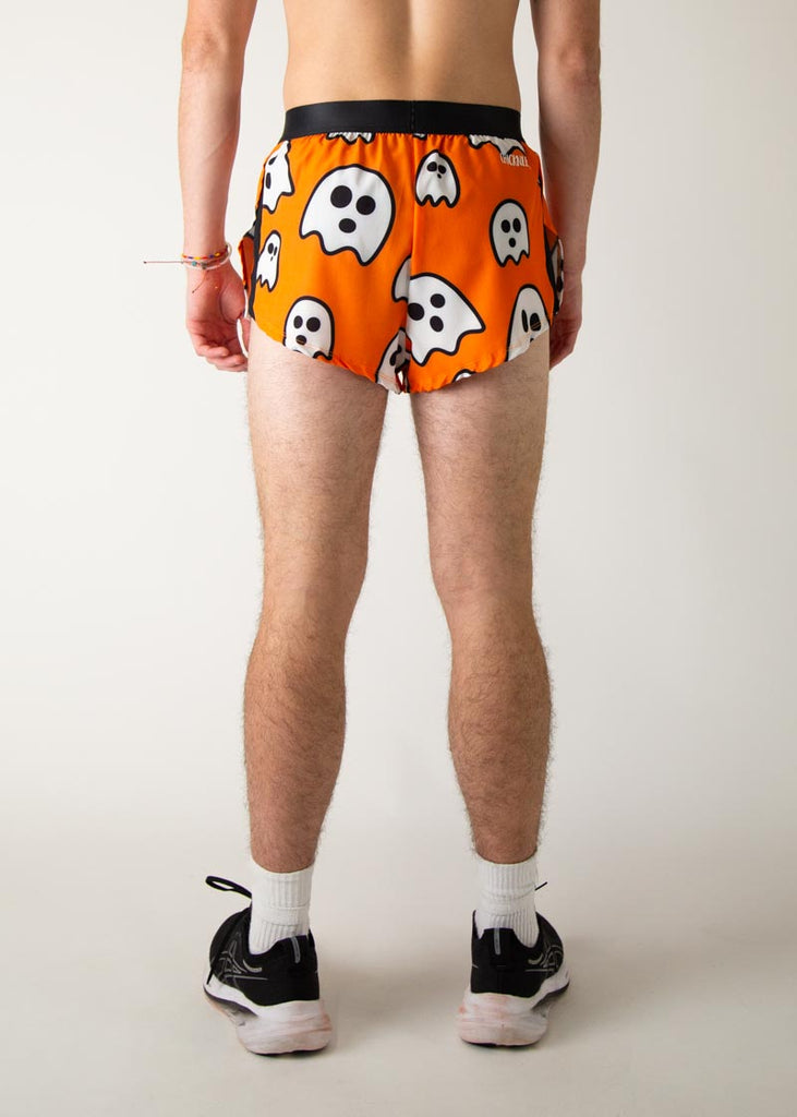 Model is a runner wearing Chicknlegs men's 2 inch split running shorts in the Ghost design, facing away from the camera to show the back.