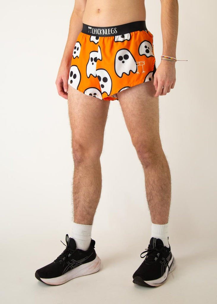Model is a runner wearing Chicknlegs men's 2 inch split running shorts in the Ghost design, facing left.
