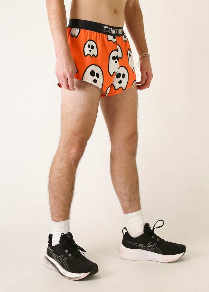 Model is a runner wearing Chicknlegs men's 2 inch split running shorts in the Ghost design, facing right.