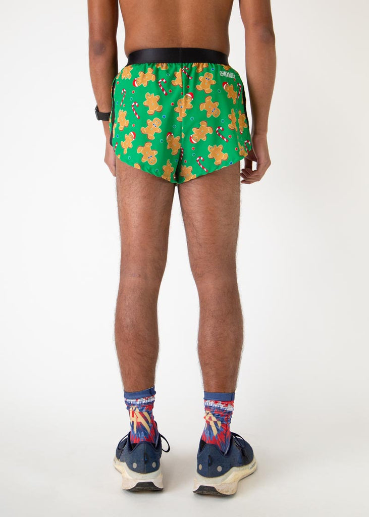 The model is a runner who is wearing Chicknlegs men's 2 inch split running shorts in the Gingerbread Men's Gingy Revenge design, facing away from the camera to show the back of the shorts.