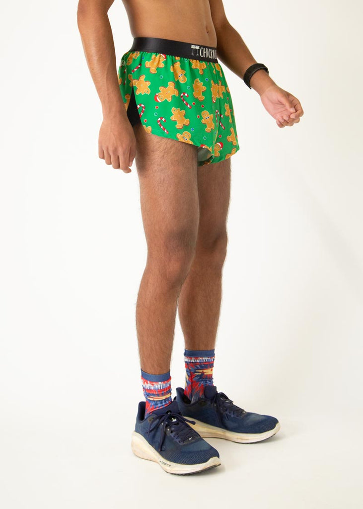 The model is a runner who is wearing Chicknlegs men's 2 inch split running shorts in the Gingerbread Men's Gingy Revenge design, facing right.