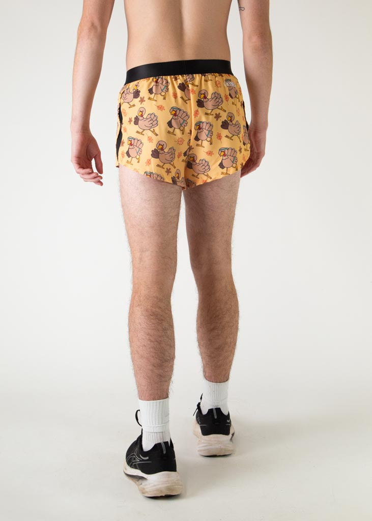 The model is a runner who is wearing Chicknlegs in men's 2 inch split running shorts in the pardoned turkey design, facing away from the camera to show the back of the shorts.