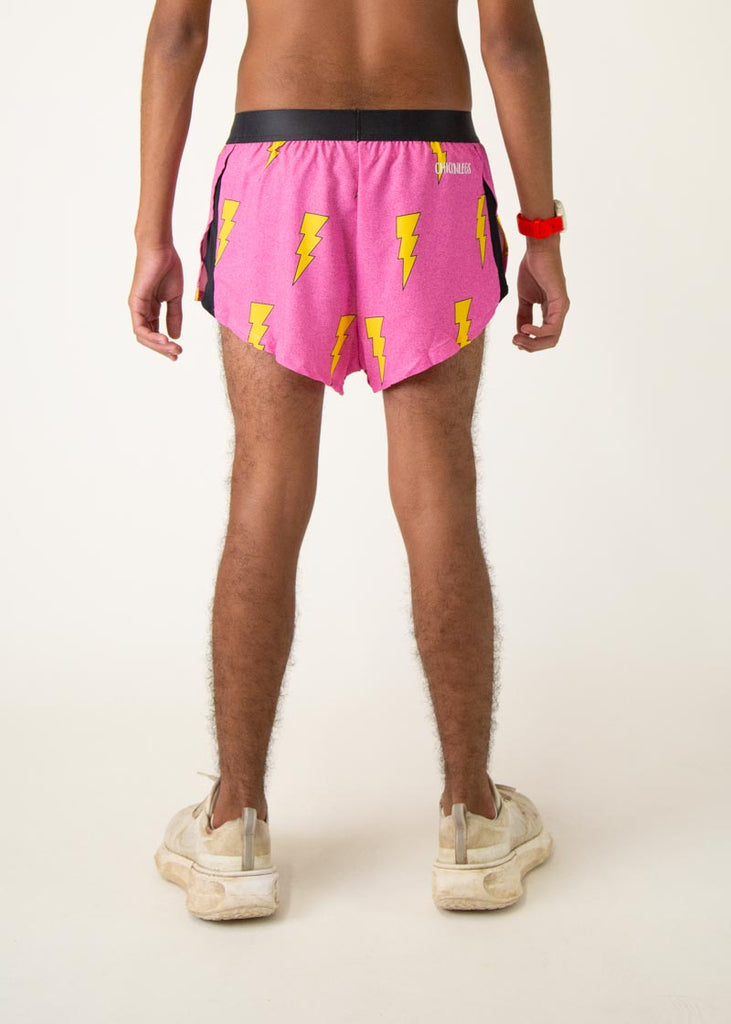The model is a runner who is wearing Chicknlegs men's 2 inch split running shorts in the pink bolts design, facing away from the camera to show the back of the shorts.