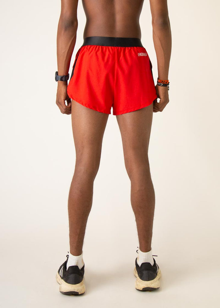 Model is wearing Chicknlegs mens 2 inch split running shorts in the red design, facing away from the camera too show the back of the shorts.