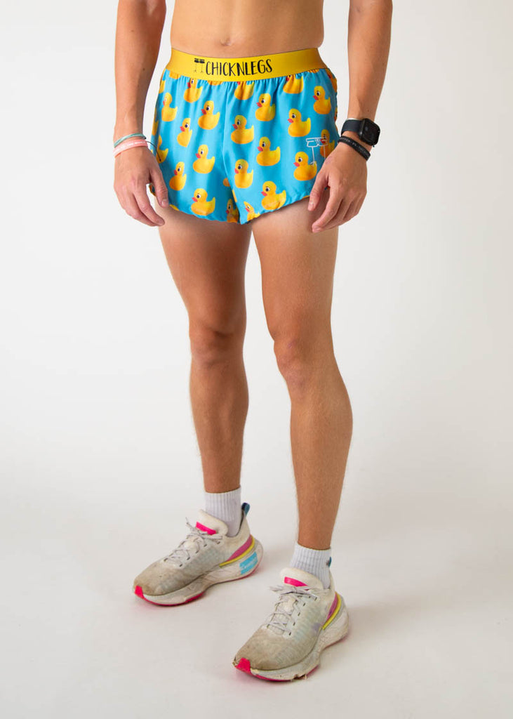 The model is a runner wearing Chicknleg's men's 2 inch split running shorts in the rubber ducky design, facing left.
