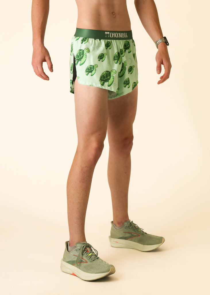 Model wearing Chicknlegs men's 2 inch split running shorts wearing the sea turtles design facing right.
