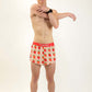 Full body shot of runner stretching while wearing the men's strawberry running shorts.