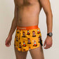 Side view of the men's 2 inch split running shorts with an orange traffic cone design.