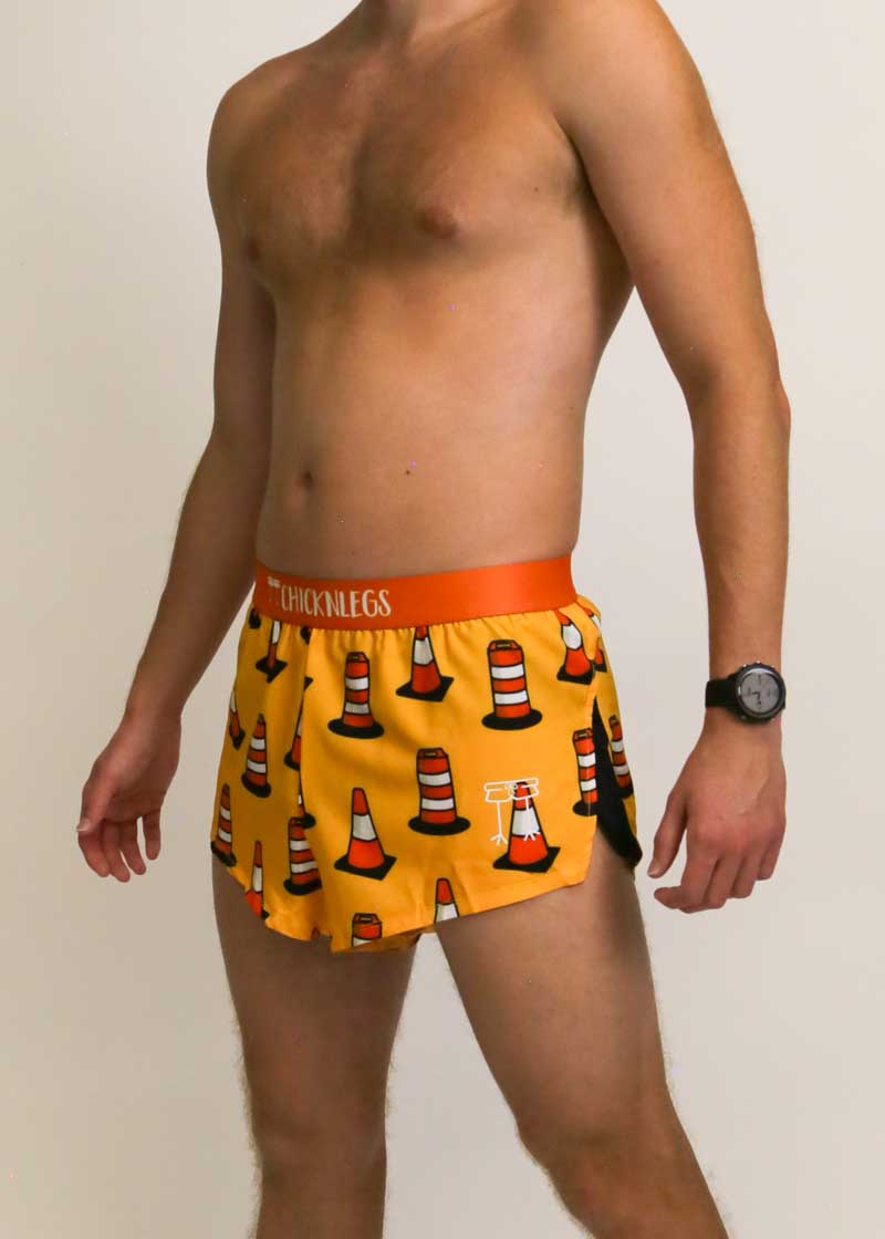 Side view of the men's 2 inch split running shorts with an orange traffic cone design.