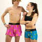 Runners matching in the men's pink bolts and women's blue bolts running shorts from ChicknLegs.