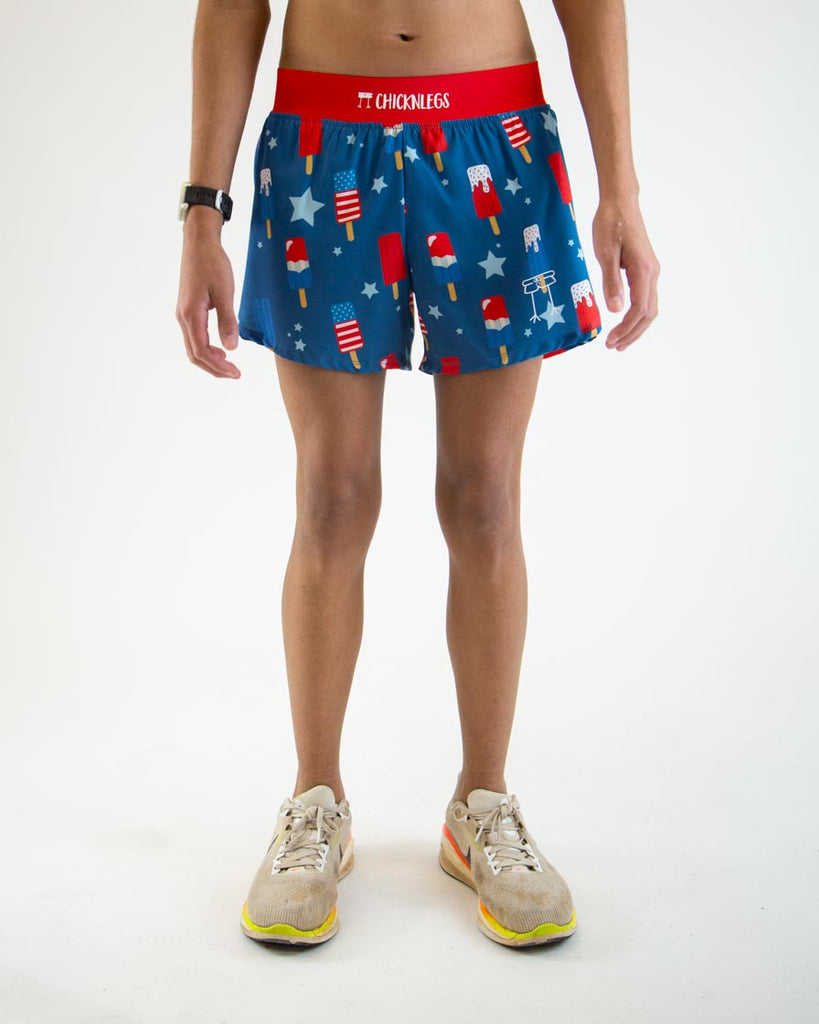 Runner is wearing ChicknLegs in the men's 4 in split running shorts in the USA Popsicle design. The print has red, white, and blue ice cream and stars. The background is blue with a red waistband.