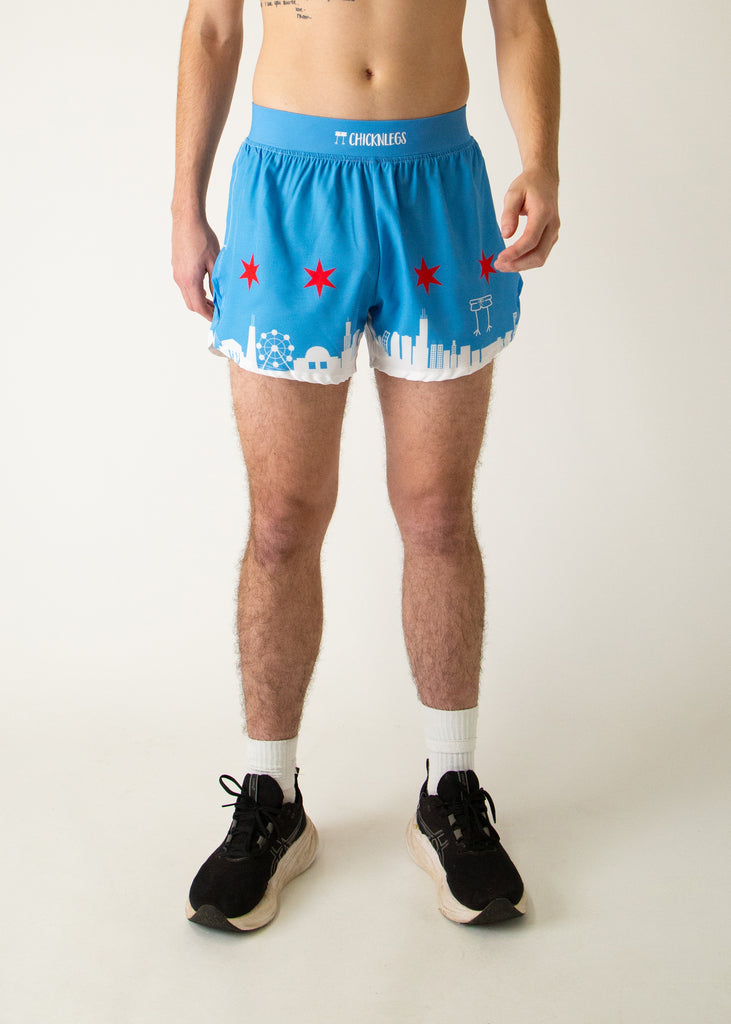 Runner is wearing ChicknLegs in the men's 4 in split running shorts that has the Chicago Style Skylines on it with a white city and blue background with red stars.
