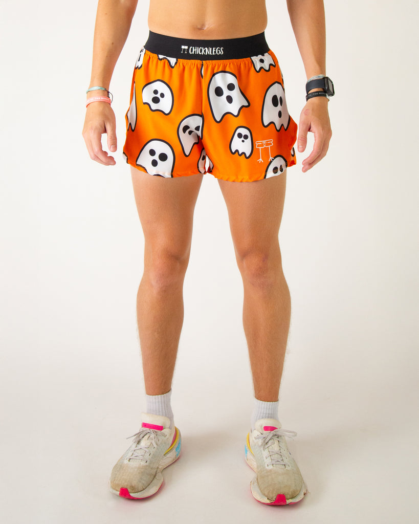 Runner is wearing ChicknLegs in the men's 4 in split running shorts in the ghost design. The print has white ghosts on it with an orange background, great for halloween and any holiday.