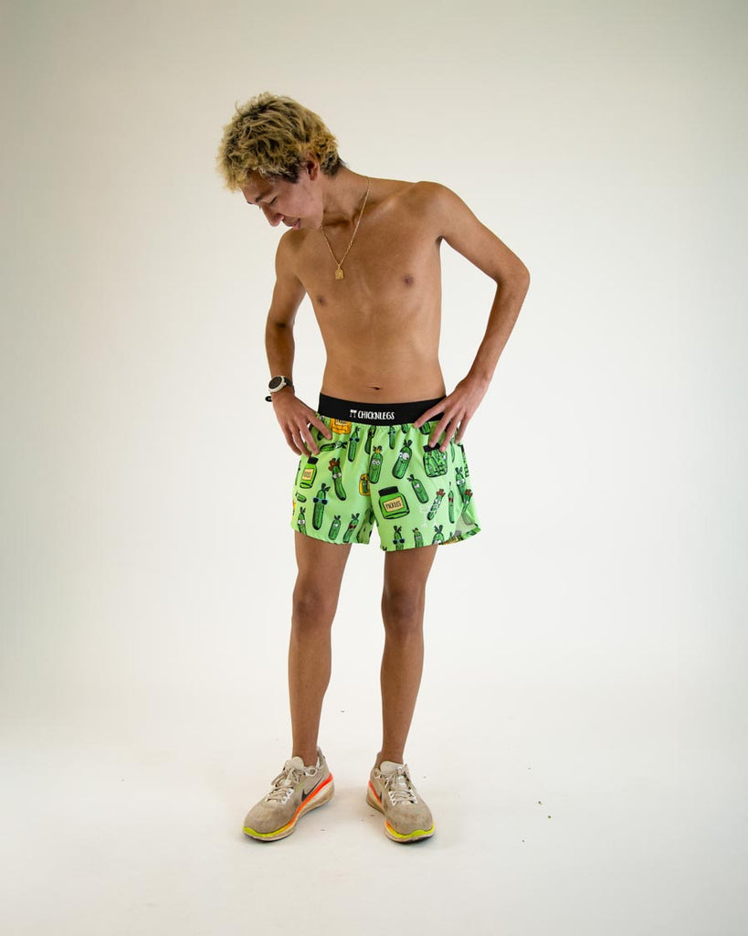 Runner is wearing ChicknLegs in the men's 4 in split running shorts in the pickles design. The model is posing while mid walking, great for runners who love pickles.