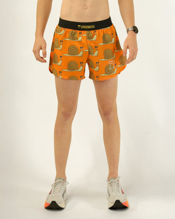 Runner is wearing ChicknLegs in a men's 4 in split running shorts with a back pocket and inner liner pocket. The print has snails on it with an orange background.