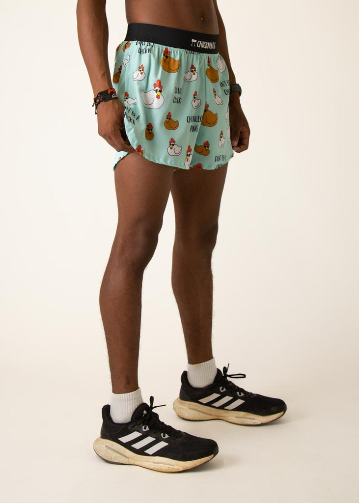 Model wearing Chicknlegs in mens 4 inch split running shorts in the swaggy chickns design, facing right.
