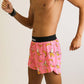 Side view of the men's pink bananas 4 inch split running shorts from ChicknLegs.