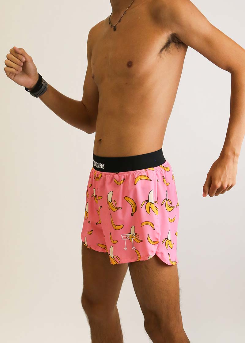 Side view of the men's pink bananas 4 inch split running shorts from ChicknLegs.