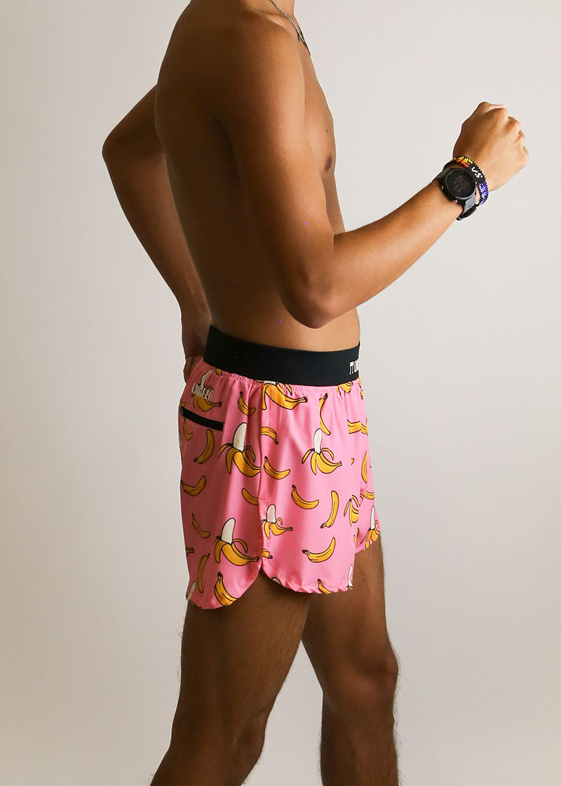 Side view of the men's pink bananas 4 inch split running shorts showing the rear zipper pocket.