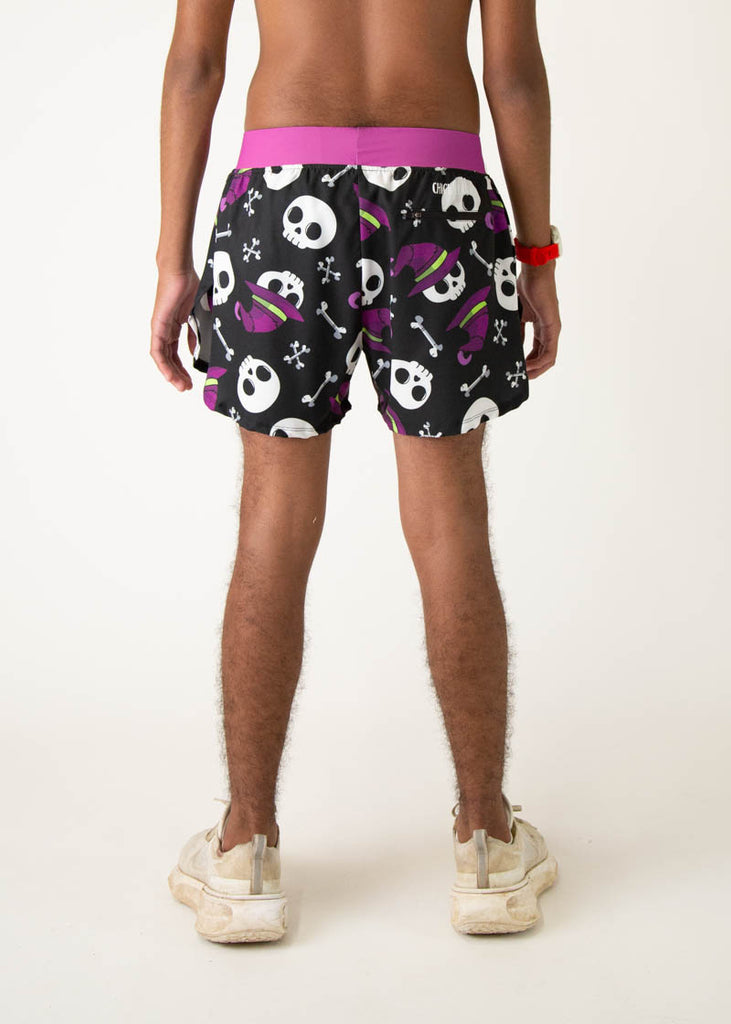 The model is a runner who is wearing Chicknlegs men's 4 inch split running shorts in the Skulls design, facing away from the camera.