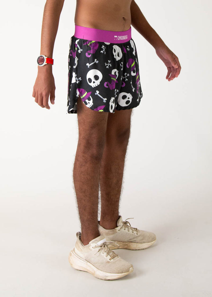 The model is a runner who is wearing Chicknlegs running shorts in the men's 4 inch split runners shorts in the skulls design, facing right.
