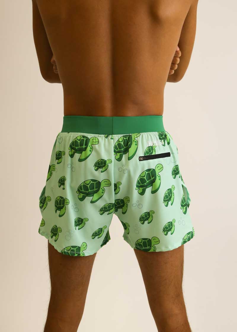 Rear view showing the zipper pocket of the men's 4 inch half split running shorts with the sea turtle design.