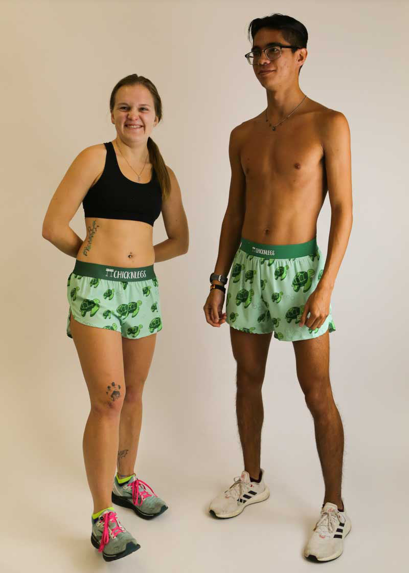 Runners smiling while wearing the sea turtle running shorts from ChicknLegs.