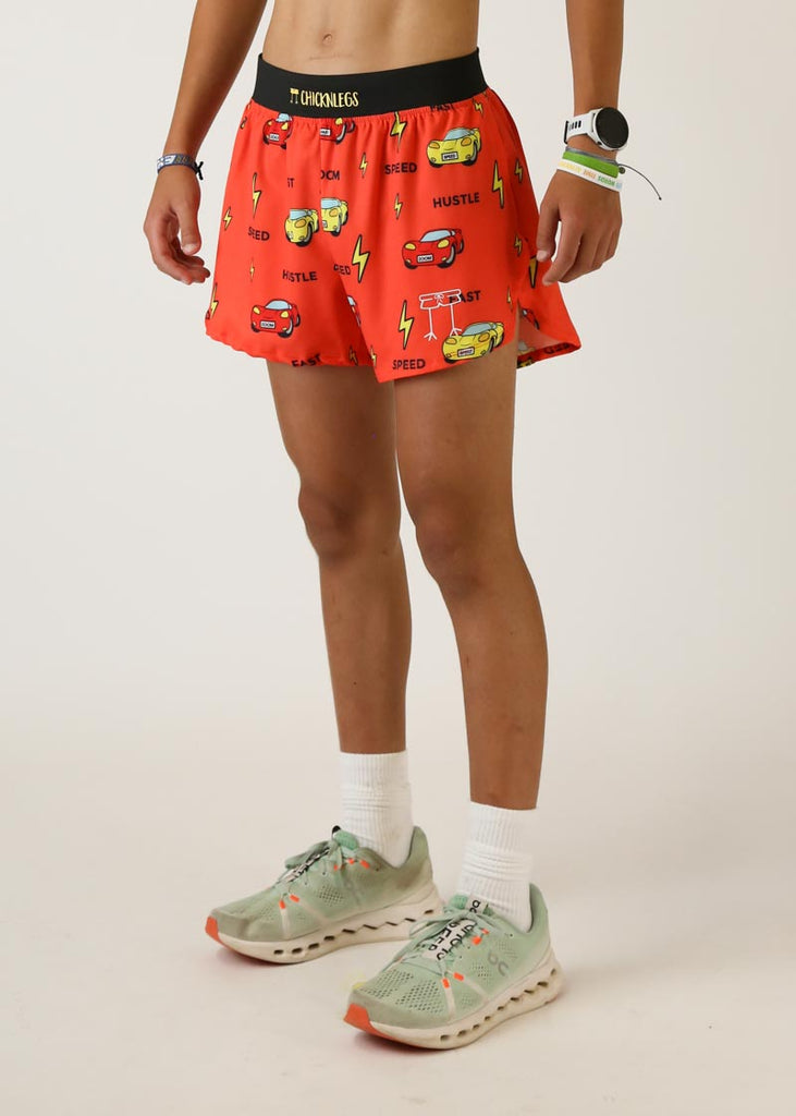 Model wearing Chicknlegs men's 4 inch split running shorts cars design left view