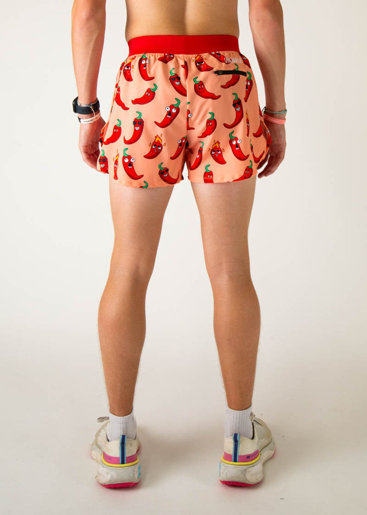 Model is a runner wearing Chicknlegs 4 inch split running shorts in the Chili Pepper design, facing away from the camera to show the back of the shorts.
